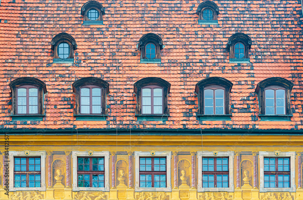 Obraz premium Tiled house roof with window in Wroclaw, Poland