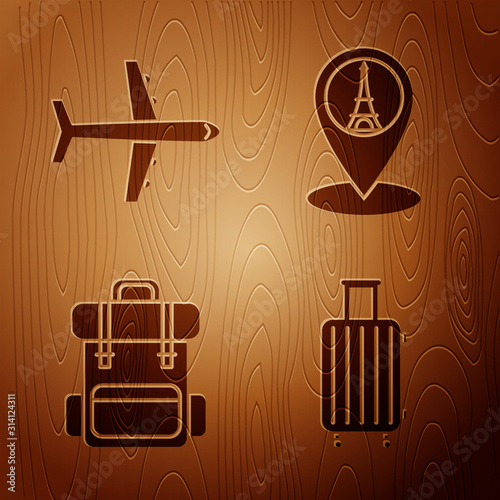Set Suitcase for travel, Plane, Hiking backpack and Map pointer with Eiffel tower on wooden background. Vector