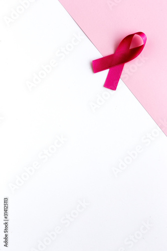 Pink ribbon on a colored background. Cancer © Eduardo Lopez