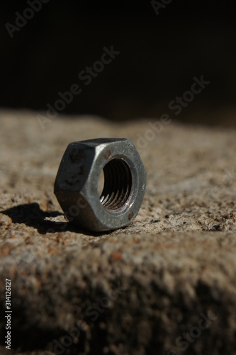 One bolt nut over a brick 1