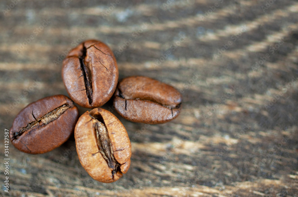 Background of roasted coffee beans, four grains in the form of a leaf Background of roasted coffee beans, four grains in the form of a leaf