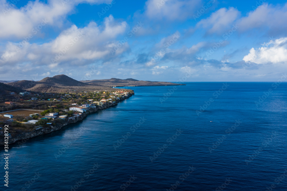 Aerial view of coast of Curaçao in the Caribbean Sea with turquoise water, cliff, beach and beautiful coral reef around beach Playa Jeremi Aerial view of coast of Curaçao in the Caribbean Sea with turquoise water, cliff, beach and beautiful coral reef around beach Playa Jeremi