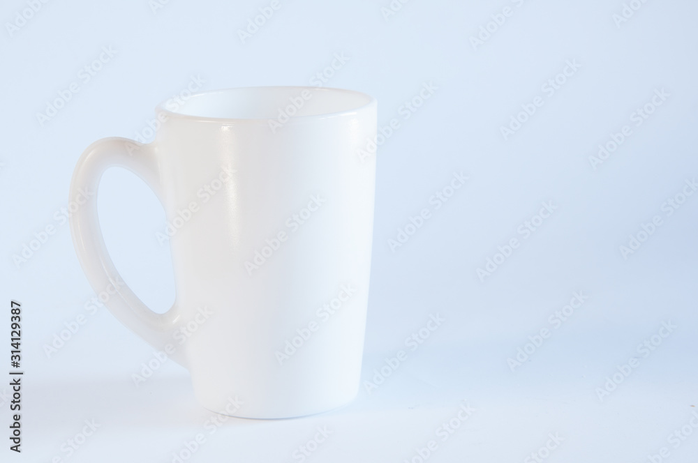 White cup for tea or coffee. On the table. On white background White cup for tea or coffee. On the table. On white background