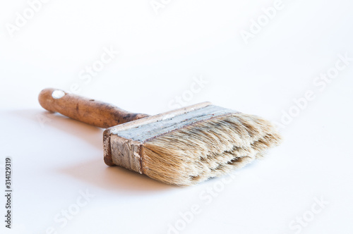 Paint brush on the table. On white background