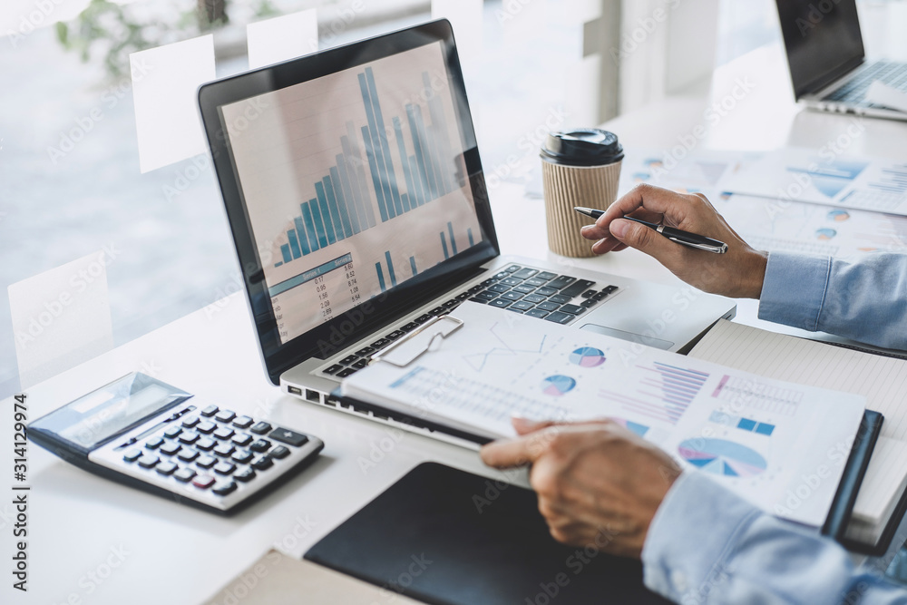 Professional at work, business woman working and analyzing on laptop with calculate statistics of financial document data graph for new project of business strategy and market growth at workplace