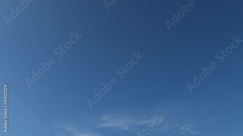 time lapse full fluffy clouds in the clear blue sky.