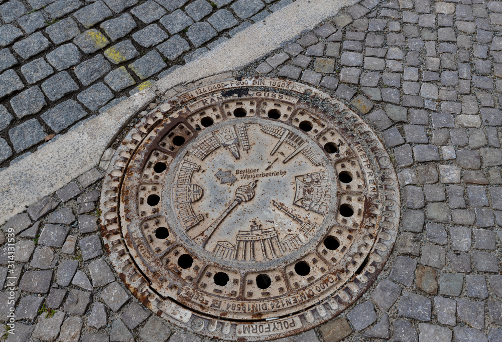 Berlin City Manhole Cover On Cobblestone