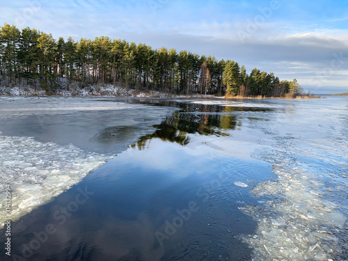 Thin ice on lake Seliger in warm winter. Russia, Tver region, Ostashkov city photo