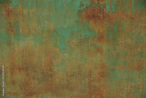 colored iron texture from part of an old green metal wall in brown rust