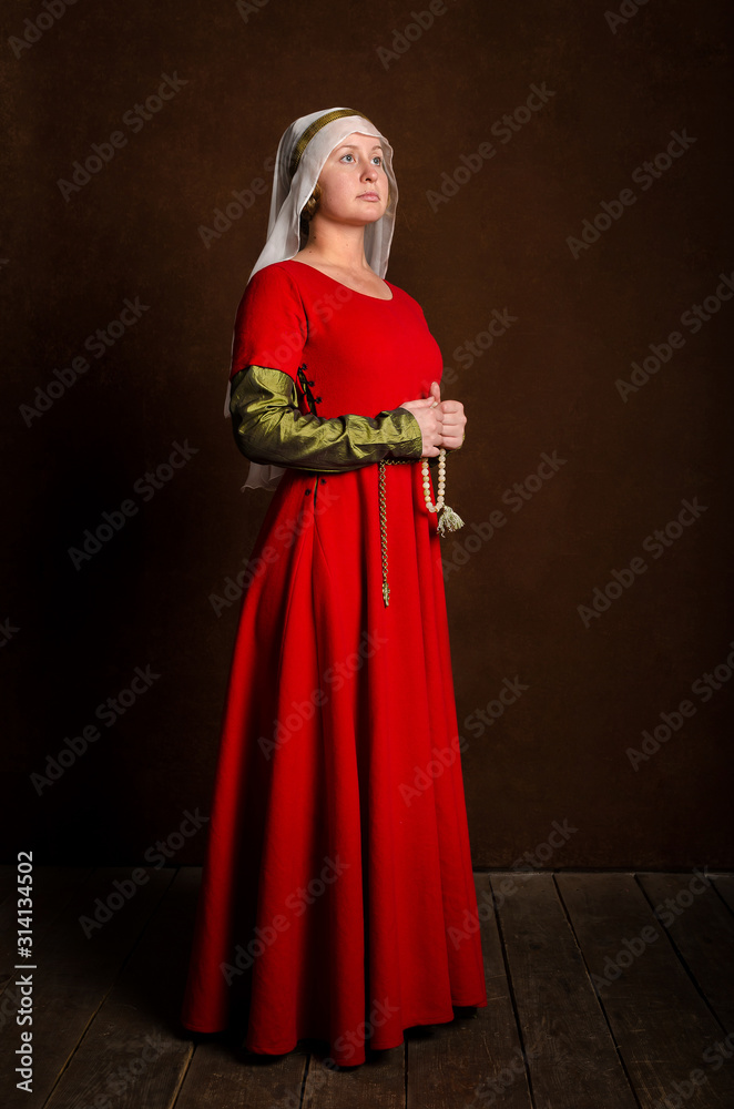 Beautiful sophisticated girl actress in a medieval costume of the 14th century central Europe. Hobby - reconstruction of historical events.