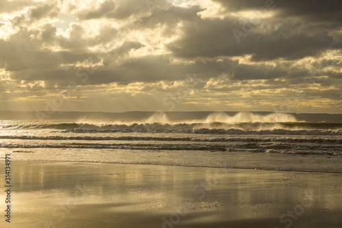 waves crashing into the shoreline at Croyde bay in North Devon