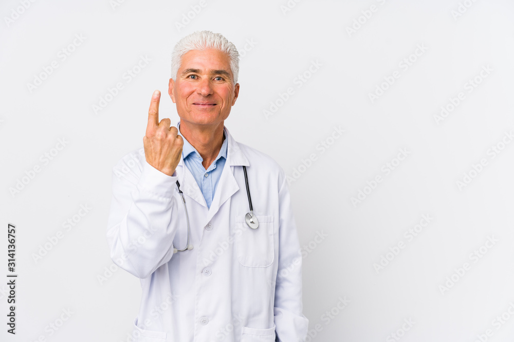 Mature caucasian doctor man showing number one with finger. Mature caucasian doctor man showing number one with finger.