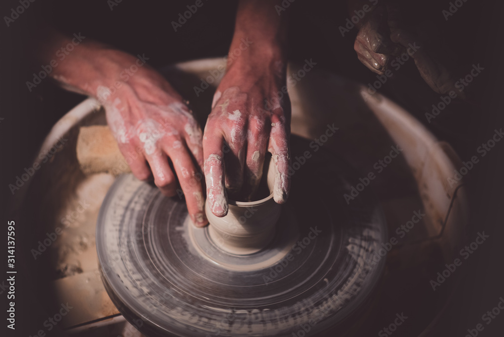 Potter with his daughter make her first clay pot Potter with his daughter make her first clay pot