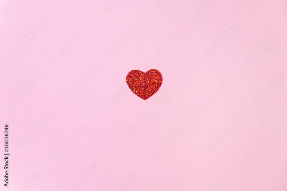a bright and sparkly red heart on a pink background