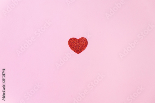 a bright and sparkly red heart on a pink background