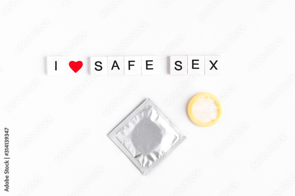 inscription i love safe sex, condom, red heart on a white background inscription i love safe sex, condom, red heart on a white background