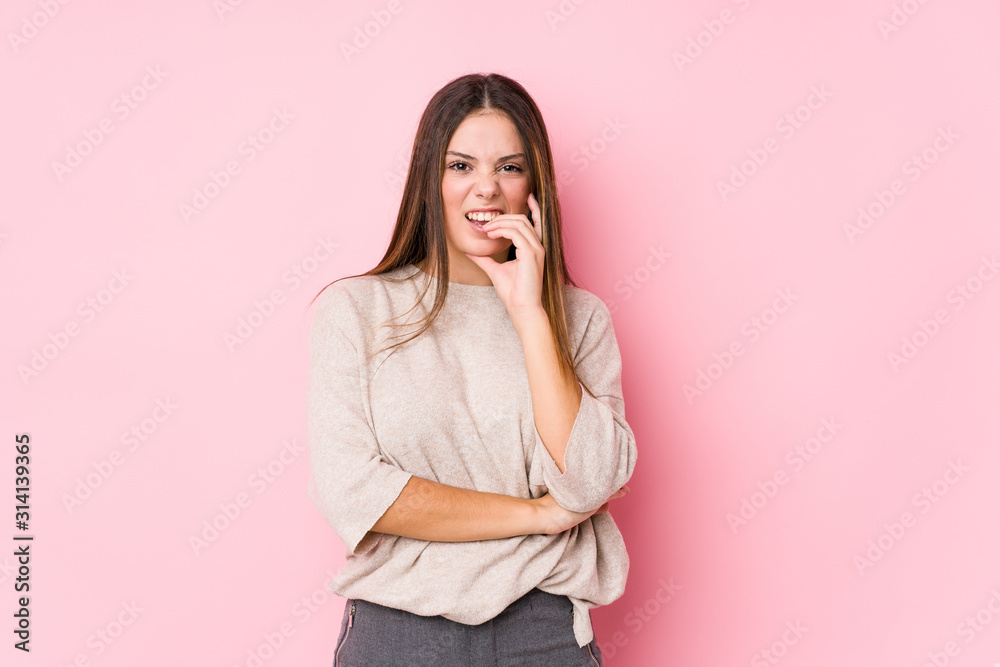 Young caucasian woman posing isolated biting fingernails, nervous and very anxious. Young caucasian woman posing isolated biting fingernails, nervous and very anxious.