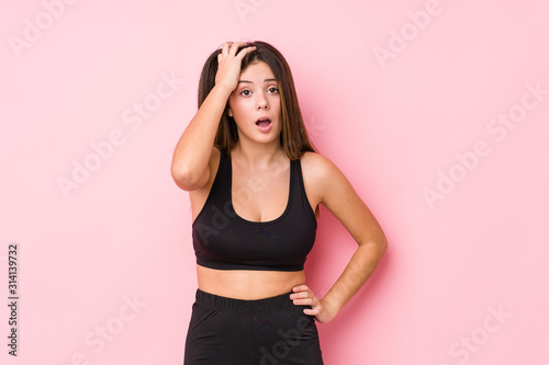 Young fitness caucasian woman isolated tired and very sleepy keeping hand on head. © Asier