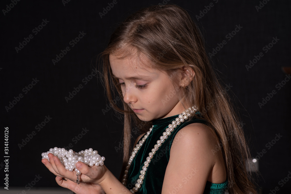Ταπετσαρία Portrait of a beautiful little girl with a beads on a dark background