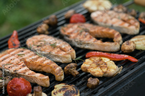 grilled salmon steaks with vegetables on the grill