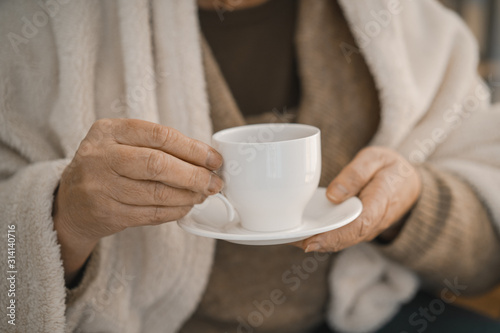 Female Hands Holding A White Cup With Hot Tea