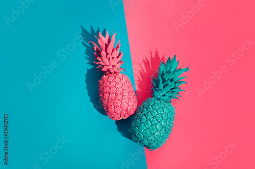 Color pineapple on pink and blue background. Surreal minimalistic art photo