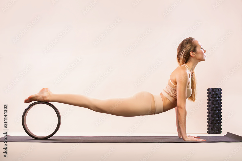 Indoor Yoga Classes. Sports recreation. Beautiful young woman in asana  pose. Individual sports. Nude sportswear. Stock Photo | Adobe Stock