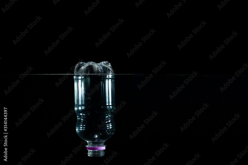 A plastic bottle floating in the sea. Pollution of the environment. Concept of pollution. A plastic bottle floating in the sea. Pollution of the environment. Concept of pollution.