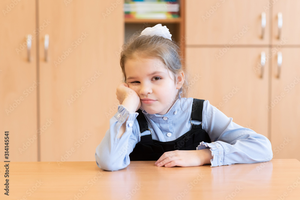 Little girl in a sundress, misses her desk. Little girl in a sundress, misses her desk.