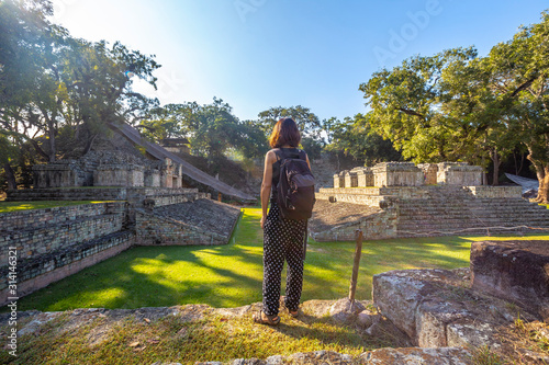 A young girl watching The ball game field in the temples of Copan Ruinas. Honduras