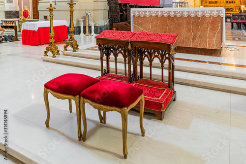 Wedding kneeler and chairs in Catholic church photo