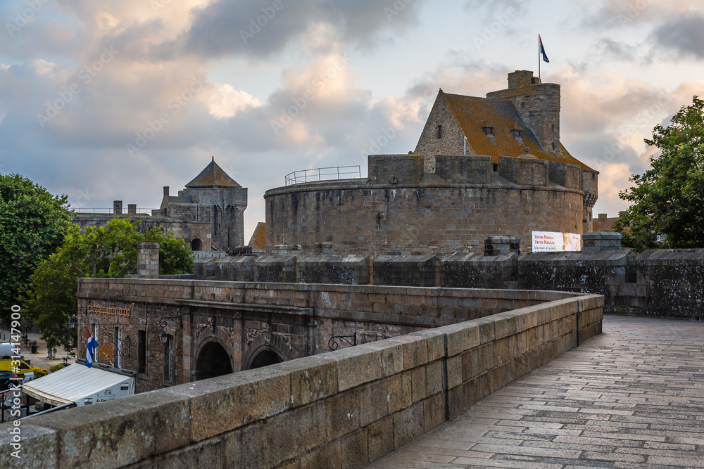 View of the old houses and the fortress of Saint-Malo from the ramparts on an early summer morning. Brittany, France.