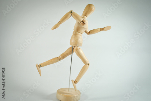 wooden mannequin with money