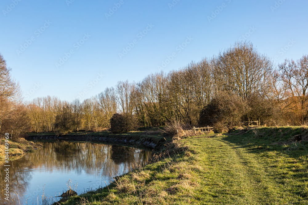 A pathway along the River Ouse in Sussex, on a sunny winters day A pathway along the River Ouse in Sussex, on a sunny winters day