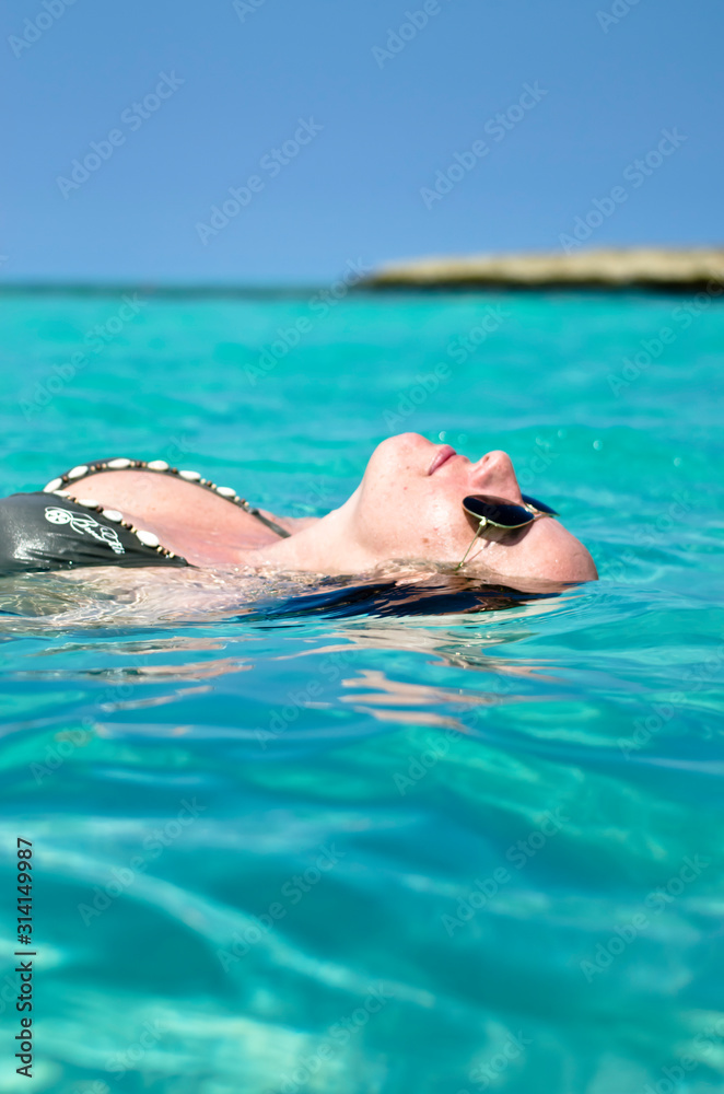Hübsche Frau schwimmt in der Karibik im türkis blauen Meer bei Varadero in Kuba, Cuba