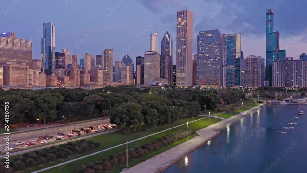 Aerial: Chicago city skyline, rush hour traffic & and Monroe Harbor on Lake Michigan at sunrise. USA Aerial: Chicago city skyline, rush hour traffic & and Monroe Harbor on Lake Michigan at sunrise. USA