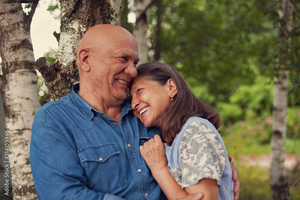 Fototapeta premium cute older man and woman in birch grove