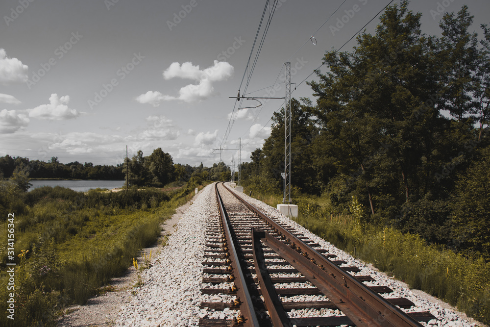 Railroad tracks with gray sky,