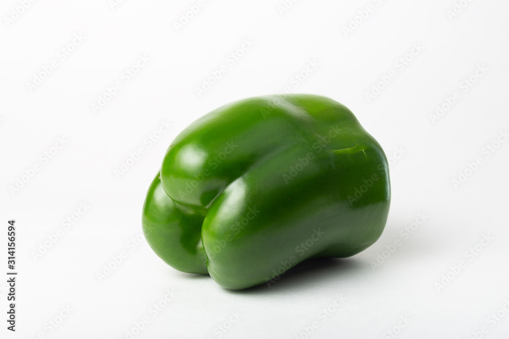 One whole green and fresh sweet bell pepper Isolated on a white background. Non-gmo healthy vegetarian eating concept One whole green and fresh sweet bell pepper Isolated on a white background. Non-gmo healthy vegetarian eating concept