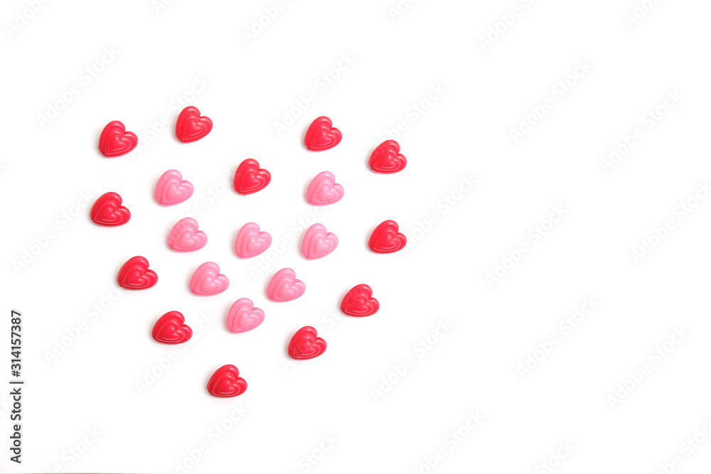 Red and pink heart beads shape - top view / flat lay with white background Red and pink heart beads shape - top view / flat lay with white background