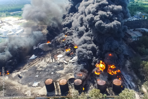 Oil storage fire. The tank farm is burning, black smoke is combu