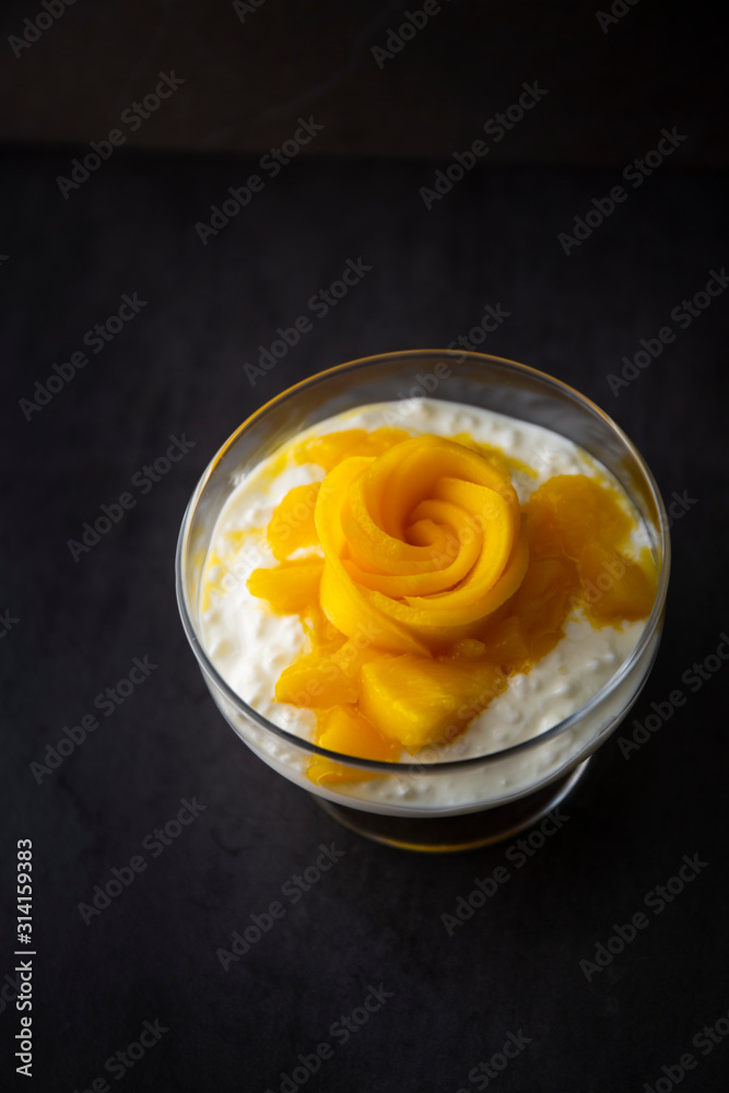 Sweet tapioca pudding with coconut milk and fresh mango flowers Sweet tapioca pudding with coconut milk and fresh mango flowers