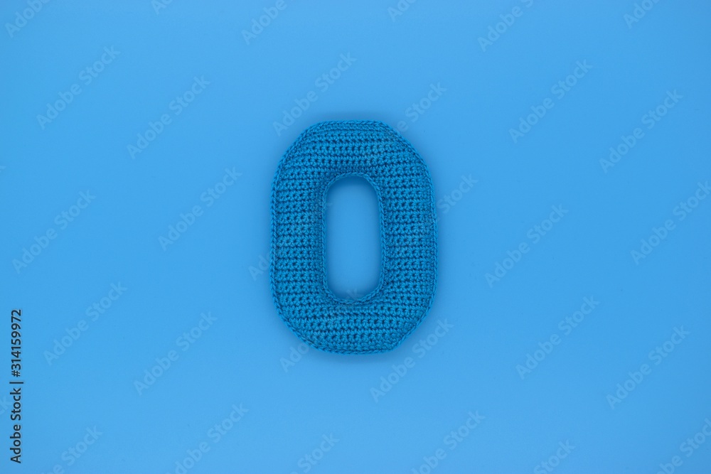 Number 0 is knitted from yarn on a blue background. Number 0 is knitted from yarn on a blue background.