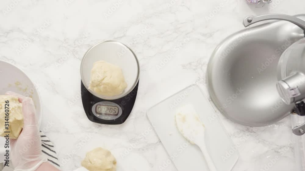 Step by step. Flat lay. Measuring cookie dough with a digital kitchen scale to bake red, white, and blue pinwheel sugar cookies.