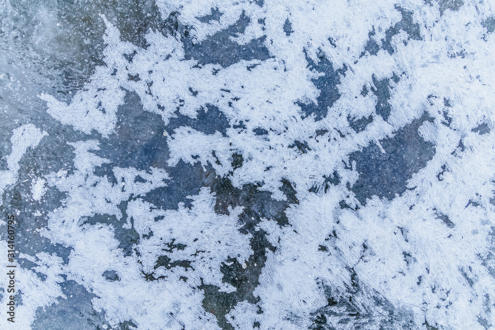 Ice texture, interesting frozen lake patterns, naturally created forms. Frozen river's water in the winter in mount Vitosha, near Sofia, Bulgaria. Ice Age climate changes. Ice texture, interesting frozen lake patterns, naturally created forms. Frozen river's water in the winter in mount Vitosha, near Sofia, Bulgaria. Ice Age climate changes.