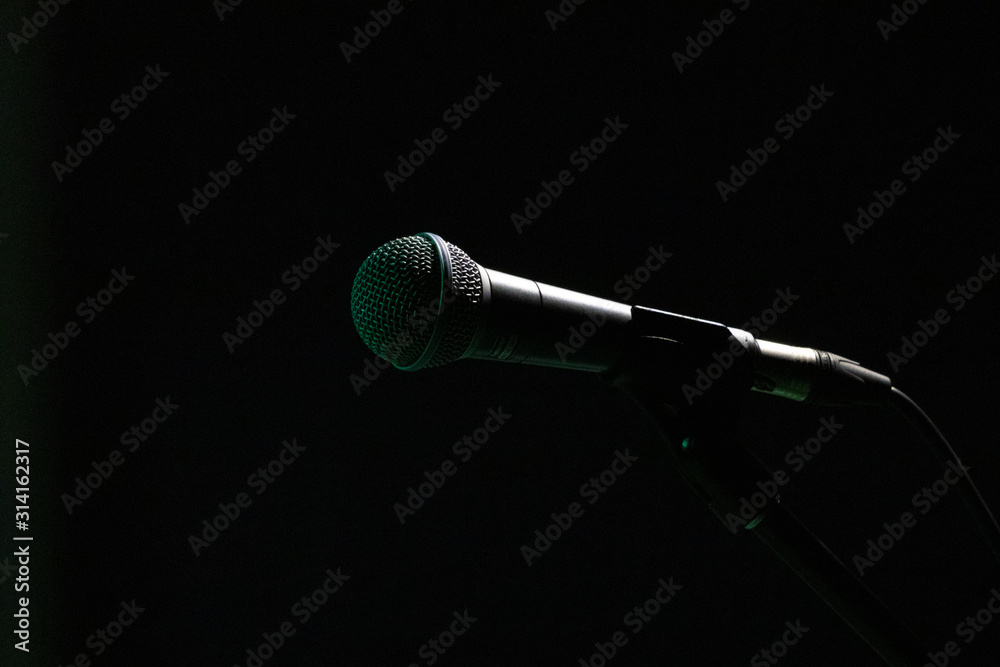 Obraz premium Isolated mic on stand. Black background.