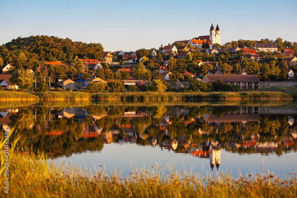 Tihany village and the abbey in suset colors with the inner lake in the front and a beautiful refletion on water at lake Balaton in Hungary