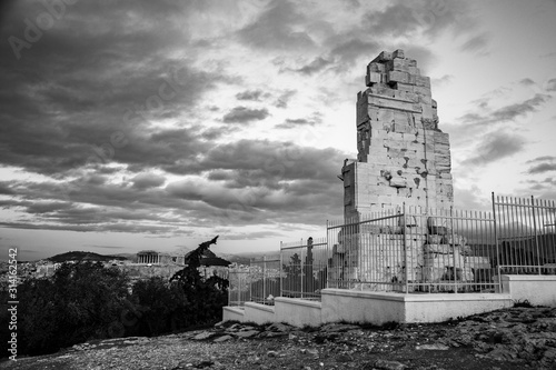 black and white photo of the Philopappu Monument and the Parthenon in background, Greek mausoleum dedicated to Gaius Julius Antiochus Epiphanes Philopappos or Philopappus in Athens, Greec photo