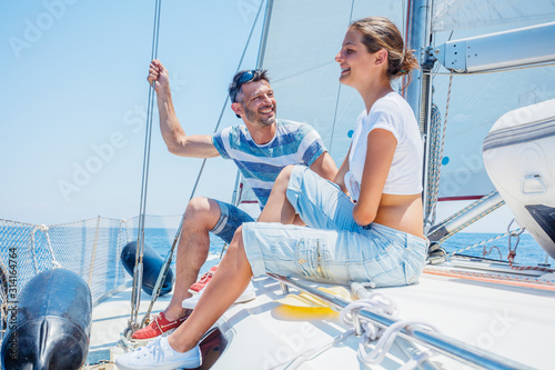 Father with adorable daughter resting on yacht