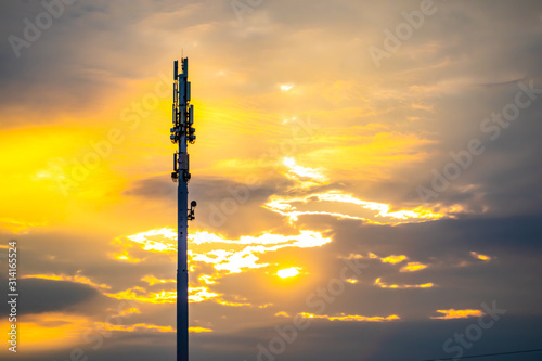 Фотография A wide angle view of a monopole cell site tower at sunset
